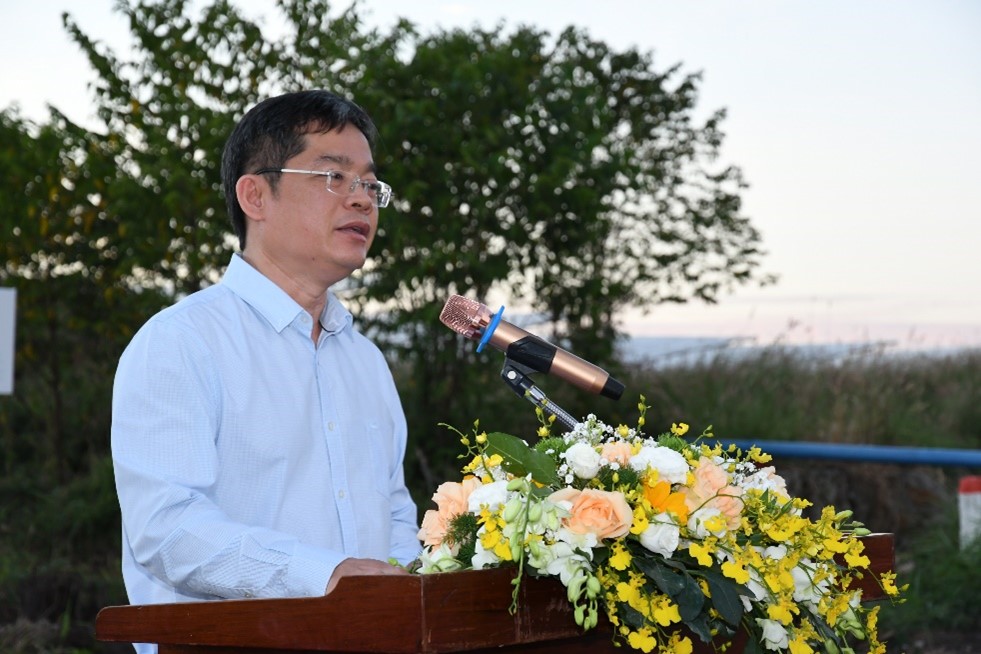 A person speaking into a microphoneDescription automatically generated