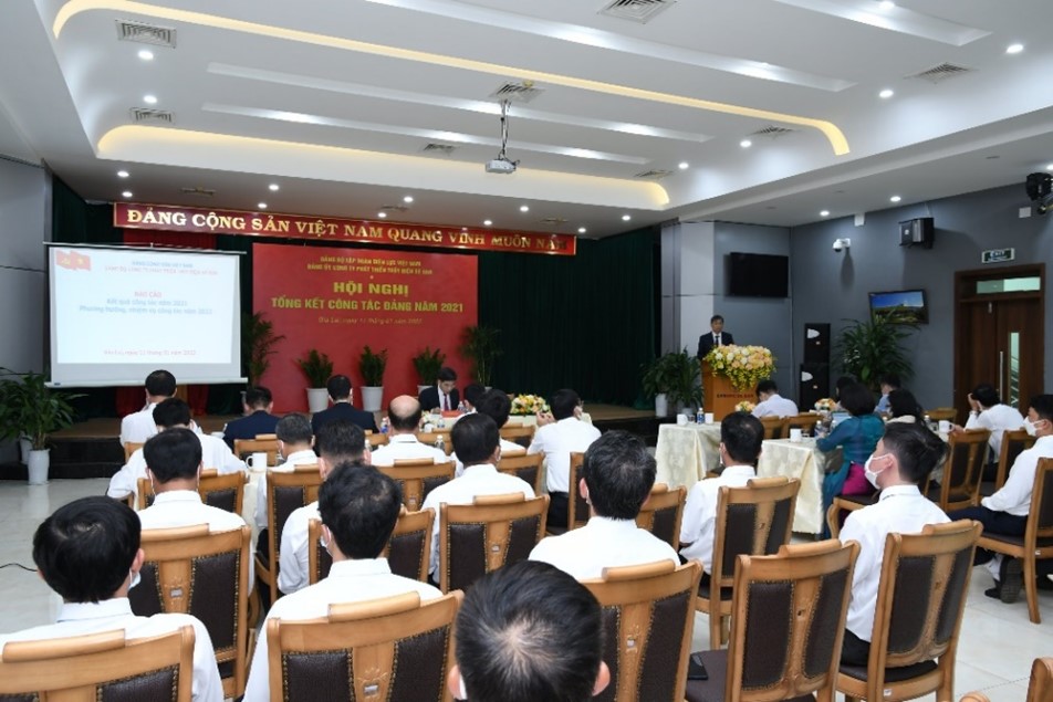 A group of people sitting in a room with a projection screenDescription automatically generated with low confidence