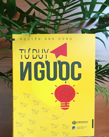 A yellow book on a plantDescription automatically generated
