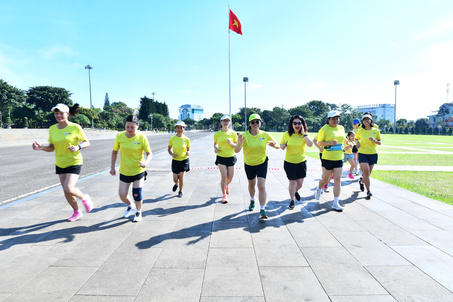 A group of people running on a streetDescription automatically generated