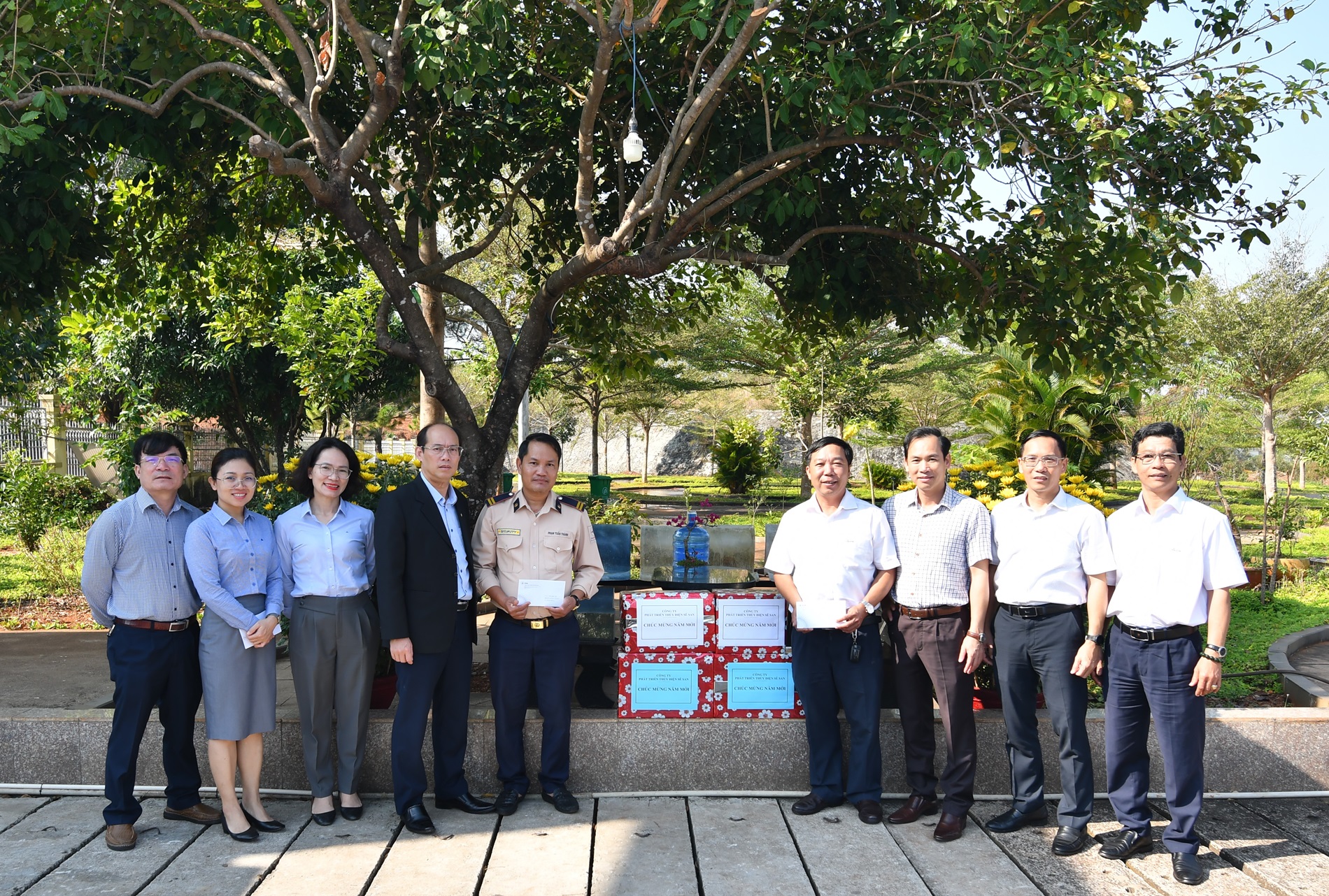 A group of people standing in front of a buildingDescription automatically generated