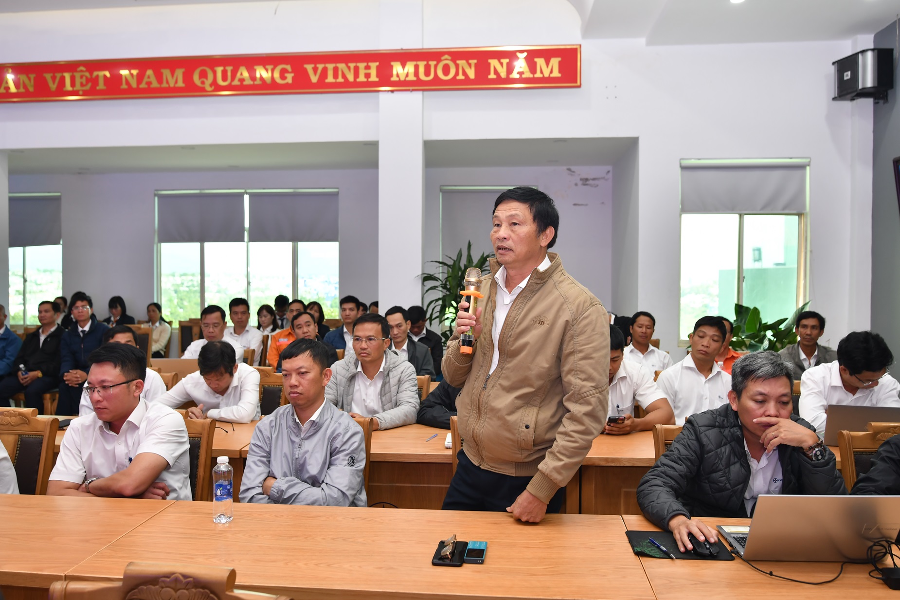 A person standing in front of a group of peopleDescription automatically generated